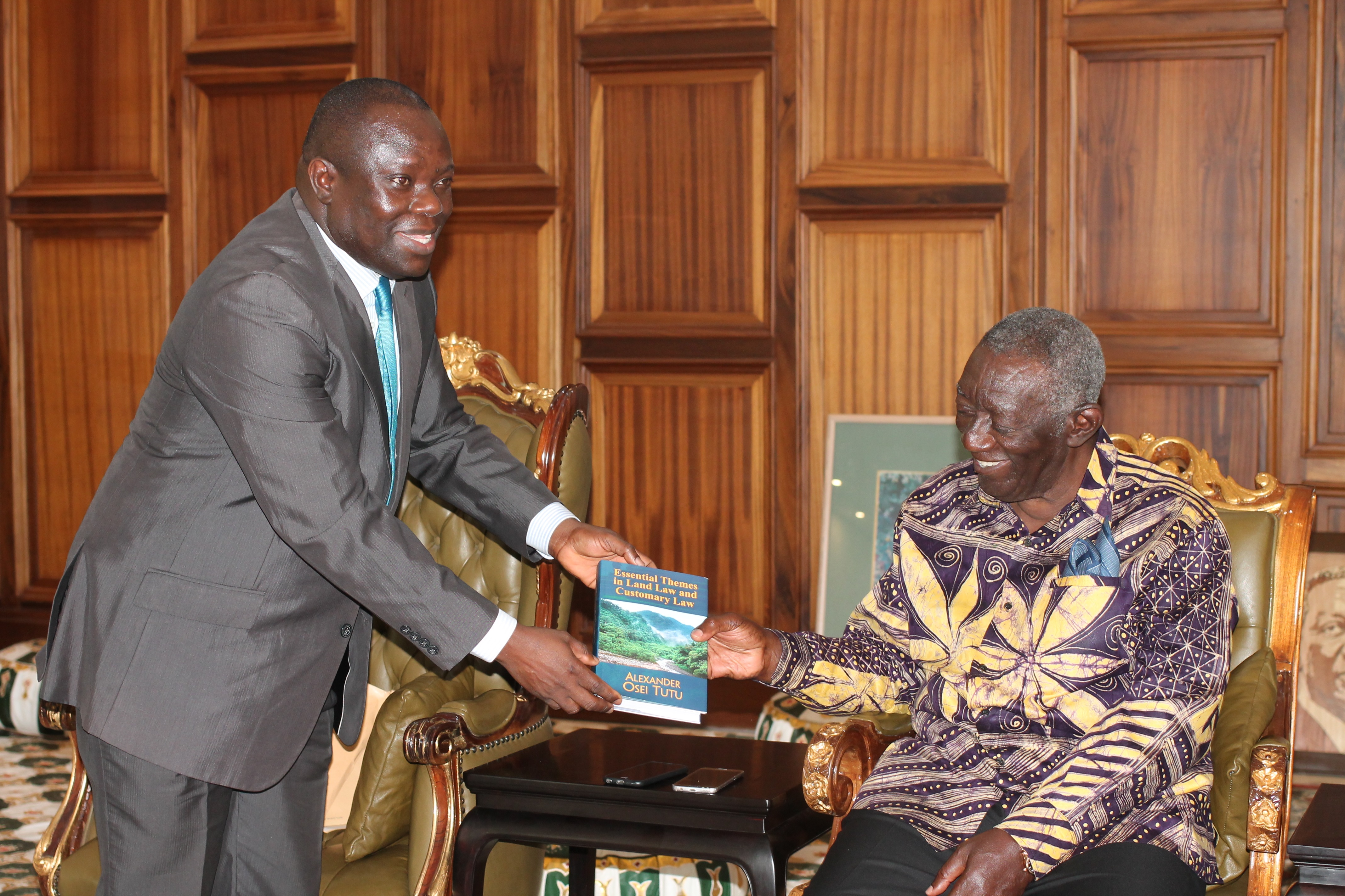 Justice Alexander Osei Tutu (left), Justice of the High Court of Ghana, presenting a copy of his book to former President John Agyekum Kufuor. Picture: MAXWELL OCLOO